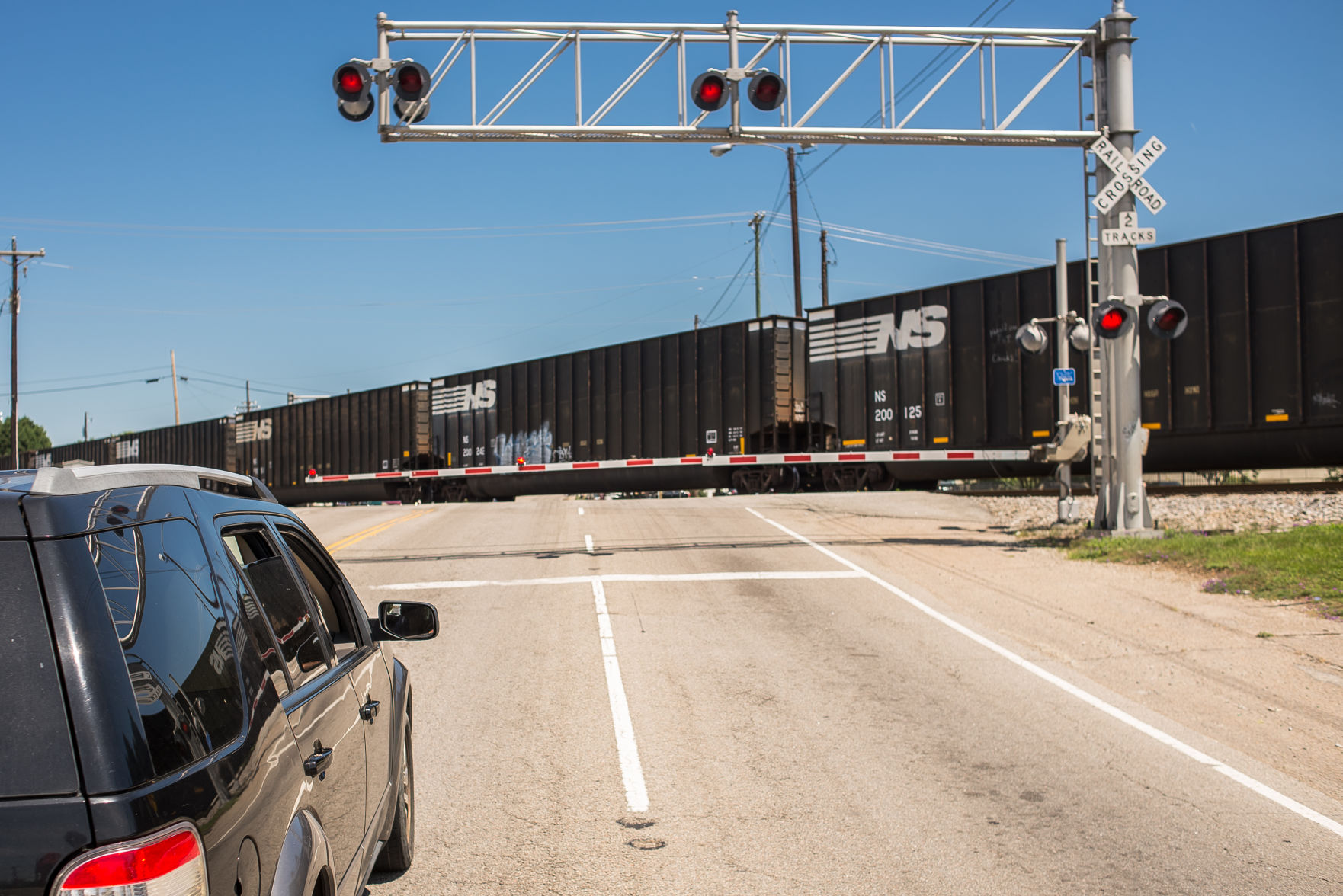 One car waiting for train to cross Assembly St.